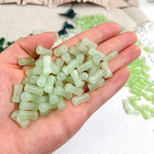 Macro shot of light green translucent bamboo-shaped glass beads for DIY jewelry making
