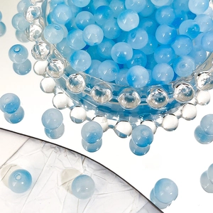 Macro detail of 8mm gradient ice blue Czech glass beads with cat eye effect luster
