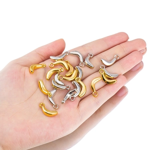 Macro detail of metallic banana-shaped jewelry charms in gold and silver finish