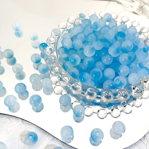 Close-up of 8mm blue gradient glass beads with ice-crack texture for DIY jewelry