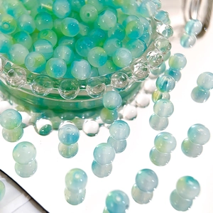 Macro shot of 8mm two-tone gradient Czech glass beads for DIY bracelet making