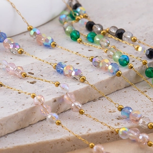 Macro shot of colorful crystal bead chains with golden stainless steel links for DIY jewelry