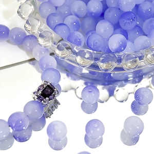 Detailed macro view of 8mm lavender Czech beads and a purple gemstone silver ring