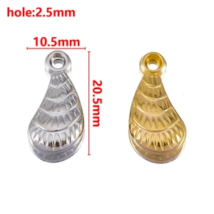 Macro view of gold and silver metallic leaf pendants with detailed radial texture and dimensions