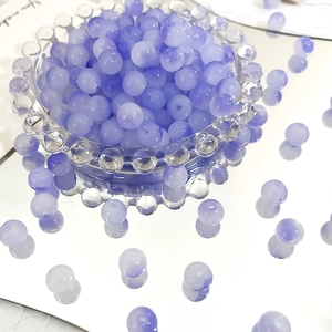 Macro detail of 8mm frosted purple gradient Czech glass beads for DIY jewelry making