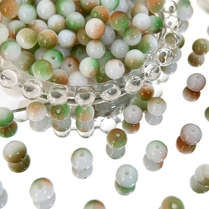 Macro detail of 8mm Czech glass beads with green and brown gradient for DIY jewelry