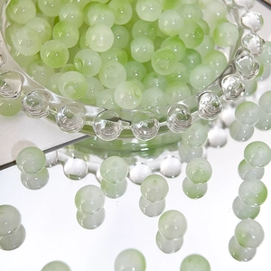 Macro shot of 8mm translucent pale green Czech beads for DIY jewelry making