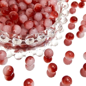 Macro shot of 8mm Czech glass beads with red and pink gradient finish for DIY jewelry
