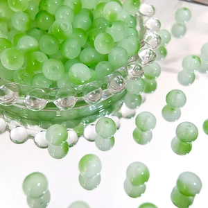 Macro shot of 8mm green translucent Czech glass beads for jewelry making and DIY crafts