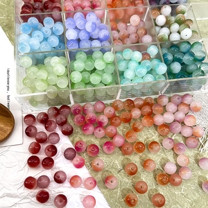 Macro detail of 8mm gradient Czech beads in a clear acrylic storage organizer box