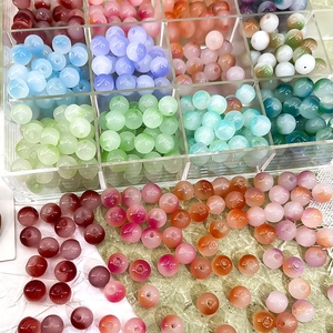 Macro view of 8mm gradient Czech beads in a 12-grid storage box for DIY jewelry making