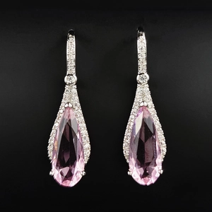 Elegant pear-shaped pink diamond drop earrings with silver pave settings on black background