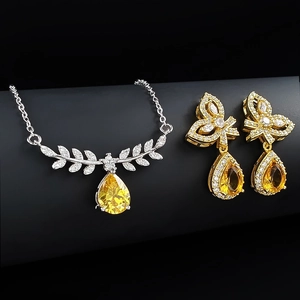 Elegant jewelry set with silver leaf necklace and golden teardrop yellow zircon earrings