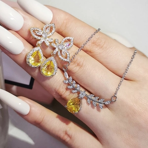 Elegant jewelry set with yellow pear-shaped stones and micro-pave butterfly wings
