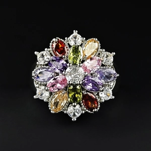 Floral cluster ring with colorful zircon stones in teardrop shapes on black background