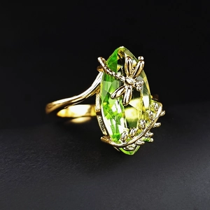 Olive green marquise gemstone ring with golden dragonfly and leaf accents