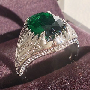 Luxurious emerald cut green gemstone ring with silver crown setting in a gift box