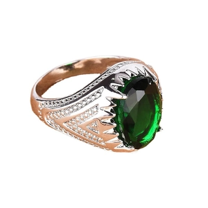 Vintage emerald green stone ring with silver filigree band and ornate detailing