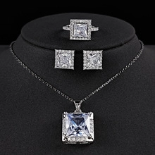 Detailed macro view of square cut zircon jewelry set including necklace, studs and ring