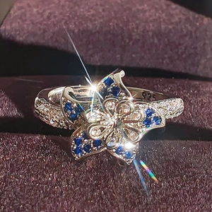 Macro shot of S925 sterling silver flower ring with blue zircons and 925 hallmark