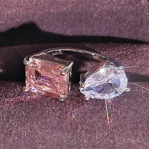 Detail of S925 silver ring featuring rectangular pink and teardrop white gemstones