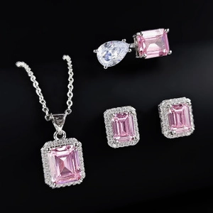 Detailed view of pink emerald-cut gemstone jewelry set with silver finish and pavé accents