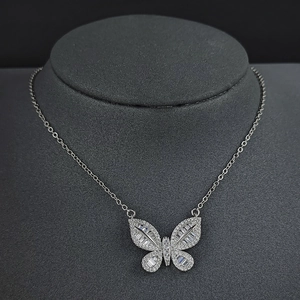 Detailed view of butterfly pendant necklace with baguette-cut and round-cut cubic zirconia