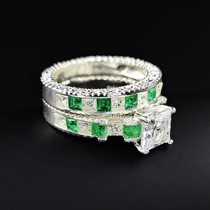 Detail shot of princess cut square zircon ring set with emerald green pave stones
