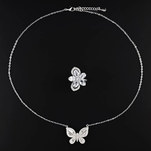 Elegant butterfly jewelry set with silver necklace and matching ring on black background