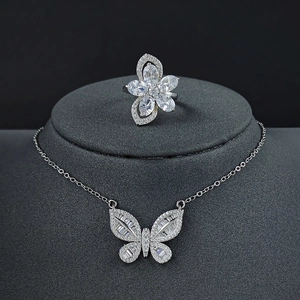 Silver jewelry set featuring a butterfly necklace and crystal floral ring for women