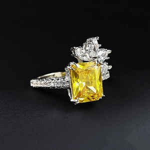Luxury silver flower ring with a radiant yellow rectangular gemstone and marquise diamonds