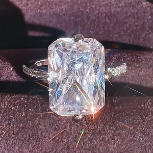 Classic emerald-cut clear gemstone ring with side diamonds on silver band for women