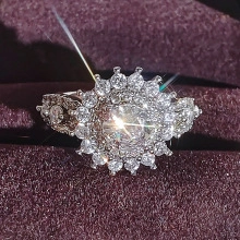 Macro shot of luxury halo sapphire ring with layered diamond cluster on purple velvet