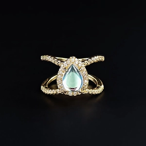 Rose gold pear-shaped moonstone ring with criss-cross band and sparkling diamonds