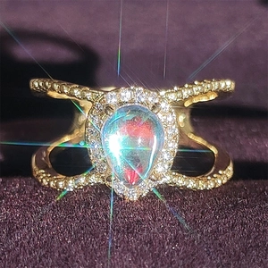 Rose gold pear shaped opal ring with double split shank and shimmering halo setting
