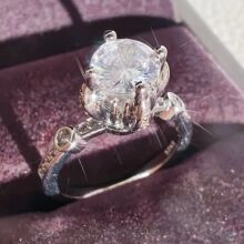 Detailed macro view of silver S925 hallmark on six-prong solitaire zircon ring band