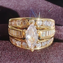 Detailed close-up of a marquise cut gold ring on a purple velvet display jewelry box