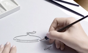 Hand-drawn sketch showing detailed design of an adjustable tennis bracelet on paper