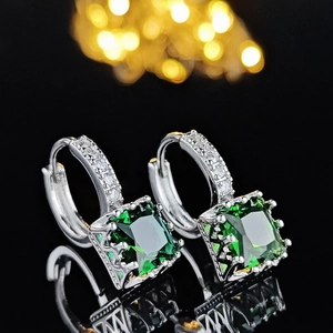 Elegant silver hoops with square green gemstones and white zircon accents on black mirror