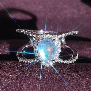 Elegant pear-shaped moonstone halo ring in silver with sparkling split shank band