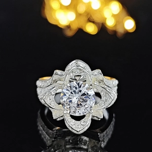 Macro view of vintage silver hollow ring with a brilliant round cubic zirconia floral design