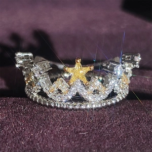 Funkelnder Kronenring mit goldenem Stern und Mikrozirkonia auf lila Samthintergrund