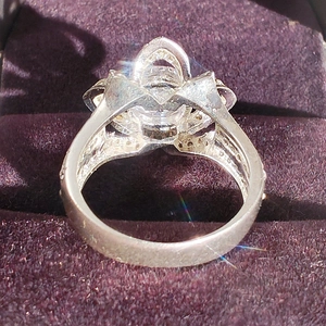 Detailed side view of luxury zircon rose flower ring in purple velvet jewelry box