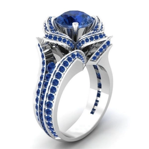 Luxurious silver flower ring with a large blue center zircon and pavé blue crystals