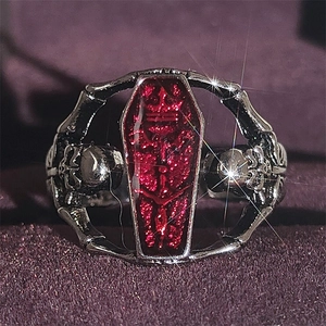 Gothic vampire coffin ring with red gem and silver skeleton arms in a punk style design