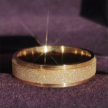 Detail of gold matte finish ring with polished edges on purple velvet jewelry box