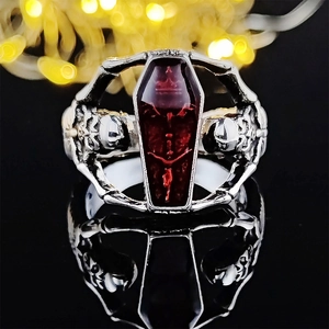 Gothic vampire coffin ring with red resin stone and silver skull details in punk style