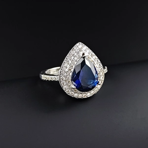 Elegant pear-shaped sea blue topaz ring with pavé crystals in silver-tone setting