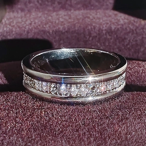 Macro shot of a silver-toned ring with a full circle of sparkling pavé-set cubic zirconia