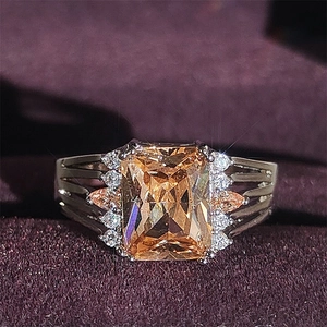 Luxurious cocktail ring with large champagne emerald-cut gem and hollow band